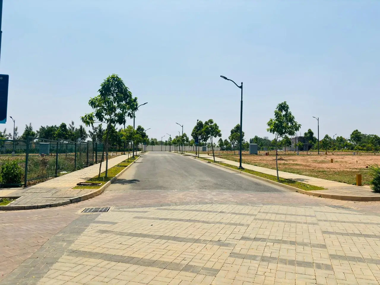 Internal road with street lights and plotted land